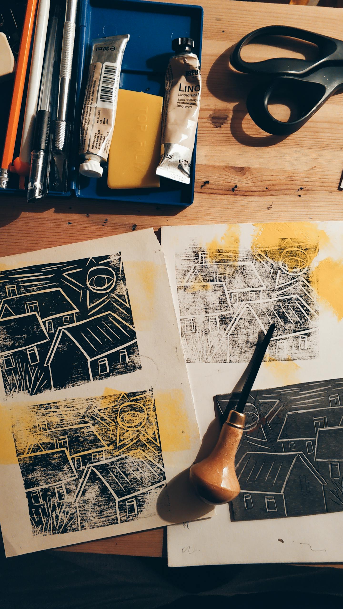 From above of creative black paints placed on wooden table with various drawings supplies